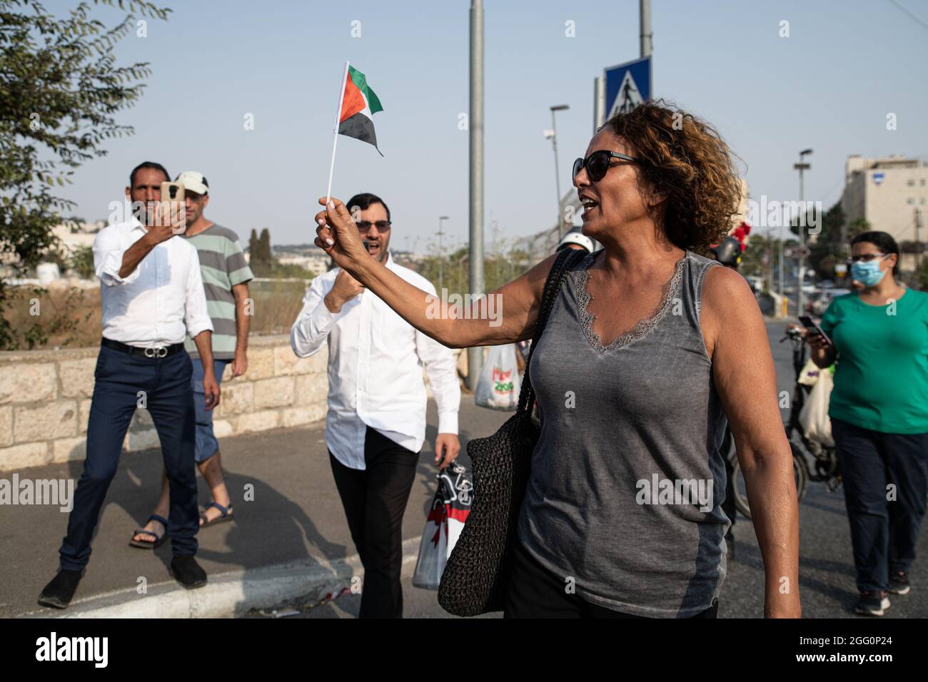 Jewish and Palestinian protestors in Sheikh Jarach during the weekly protest in front of the Israeli Police checkpoint at the entrance to the neigberhood - which is monitoring entrance of non-residents since last April. Sheikh Jarach. Jerusalem, Israel. 28th Aug 2021. (Photo by Matan Golan/Alamy Live News) Stock Photo