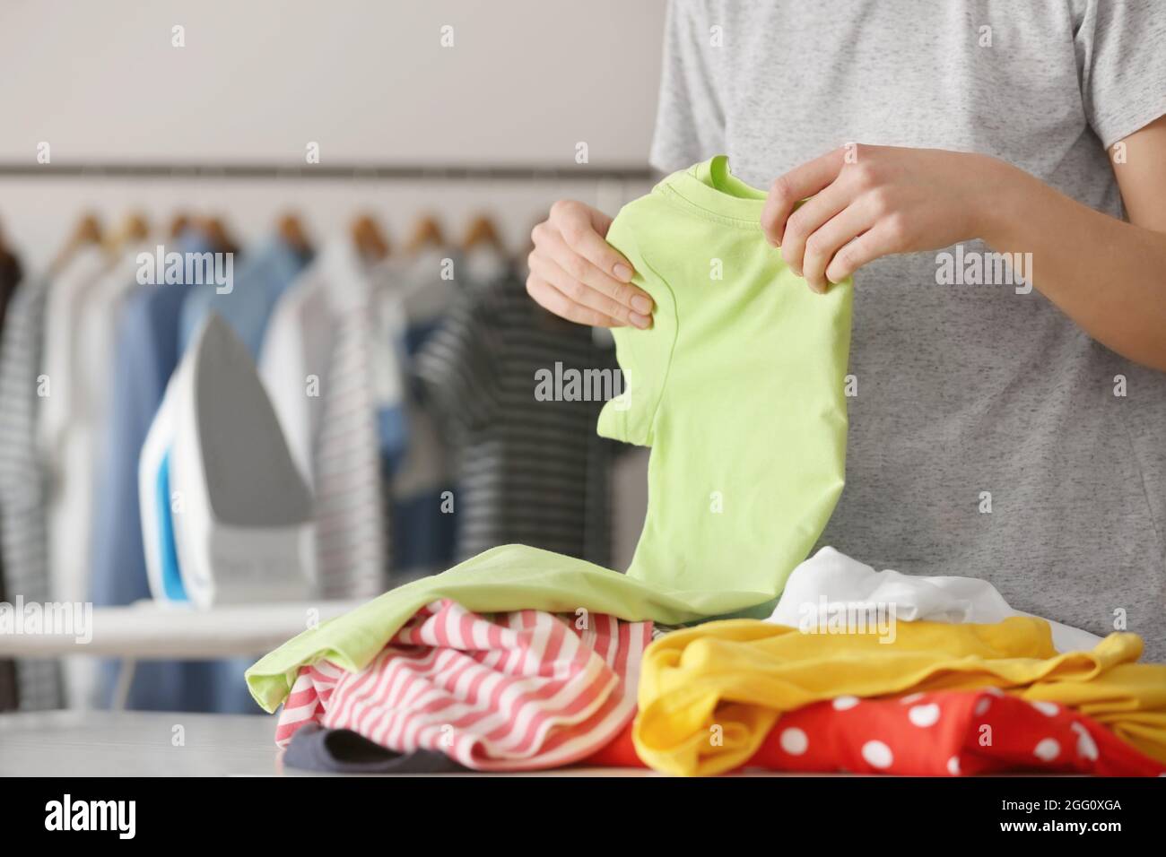 Woman folding clothes after ironing, closeup Stock Photo Alamy