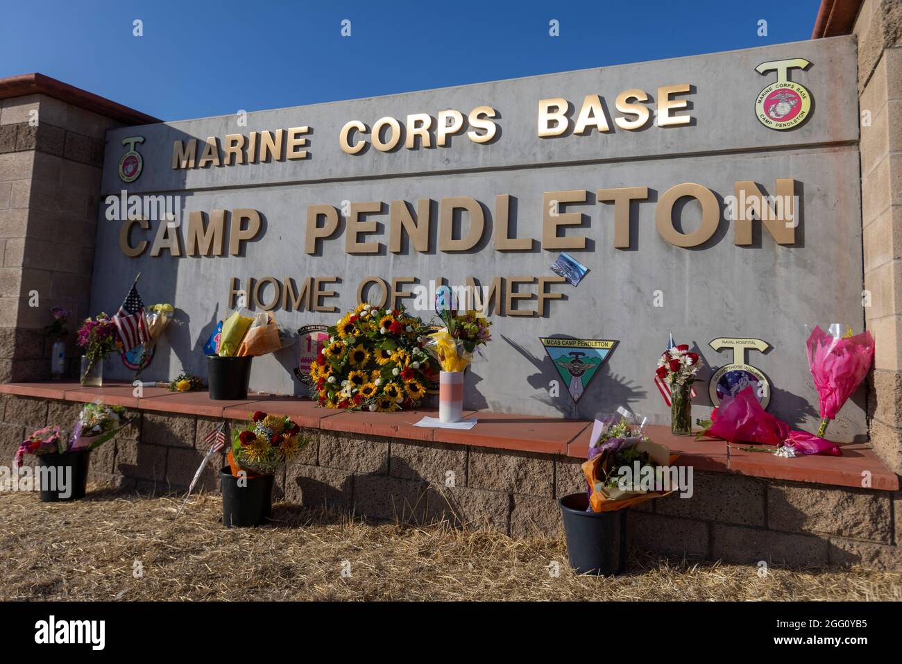 Following the bombing at Hamid Karzai International Airport in Kabul, Afghanistan, flowers are shown placed at the main gate to U.S. Marine Base Camp Pendleton in Oceanside, California, U.S., August 27, 2021.      REUTERS/Mike Blake Stock Photo