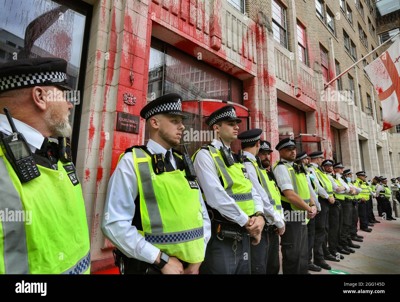 Police officers cordon off the Guild Hall which is covered with paint