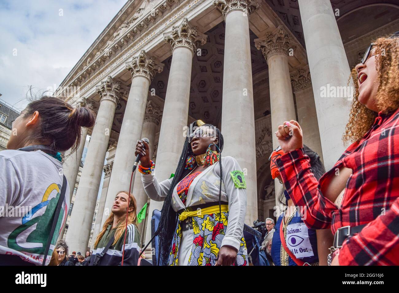 London, UK. 27th Aug, 2021. Activist Marvina Newton speaks to the protesters outside The Royal Exchange during the demonstration. Extinction Rebellion protesters staged the Blood Money March, part of their two-week Impossible Rebellion campaign, targeting the City of London, the capital's financial hub. Credit: SOPA Images Limited/Alamy Live News Stock Photo