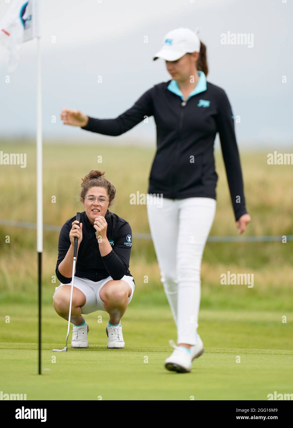 Team GB&I's Emily Toy lines up a putt on the first green during the 2021 Curtis Cup Day 1 - Morning Foursomes at Conwy Golf Club, Conwy, Wales on 26/8 Stock Photo