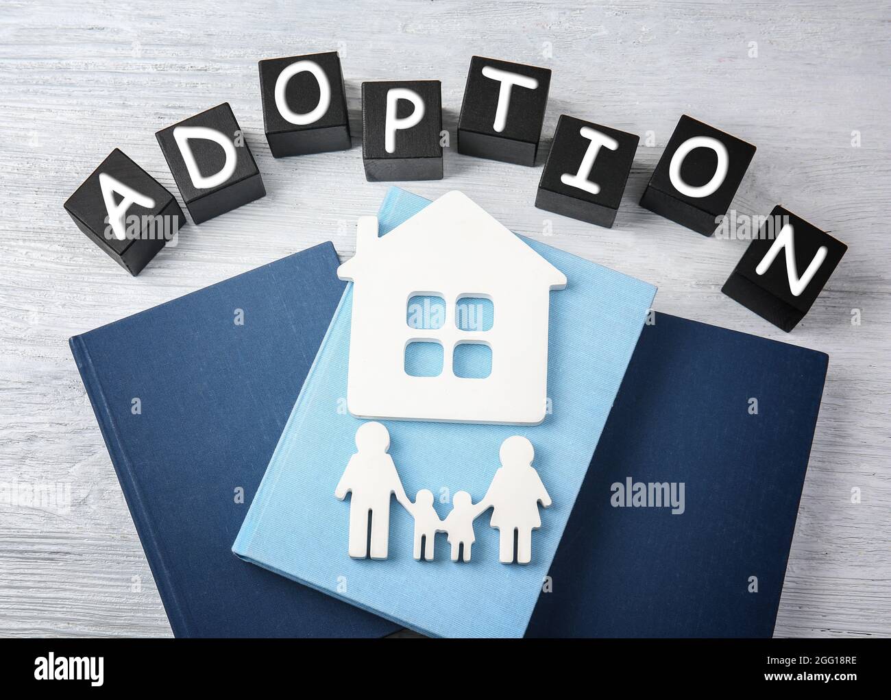 Adoption Notepadss Black cubes with word ADOPTION, decorative figures and notepads on ...