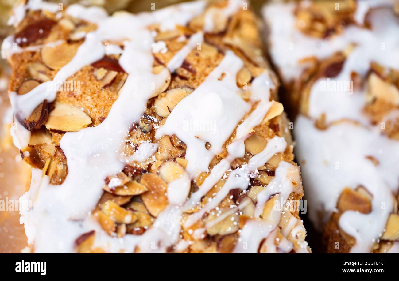 Dessert bread with white icing and nuts Stock Photo