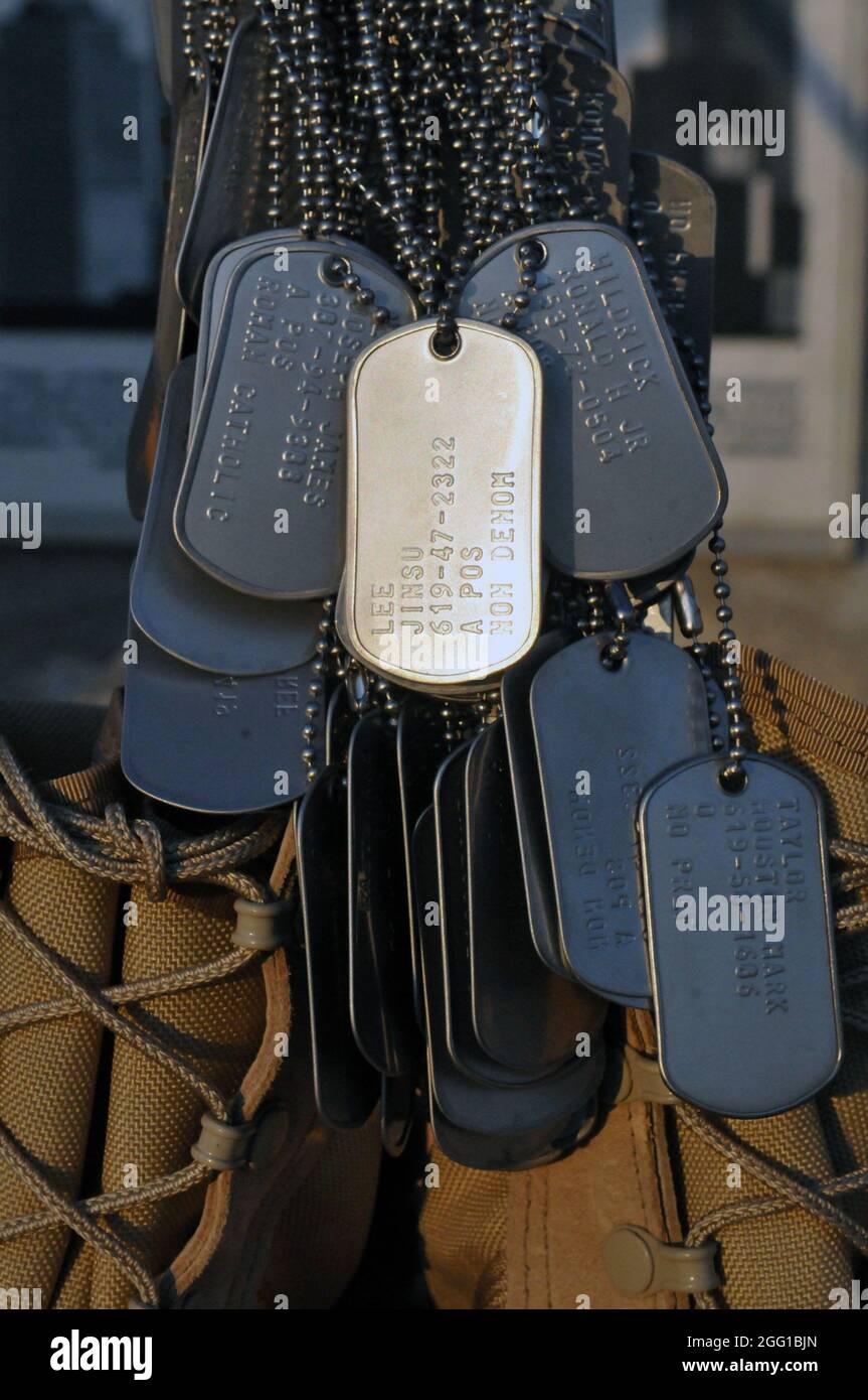 Dog tags from 3rd Brigade Combat Team, 25th Infantry Division, Task Force  Bronco‚Äôs fallen heroes hang from a pair of combat boots as part of a  sunrise memorial held to honor those