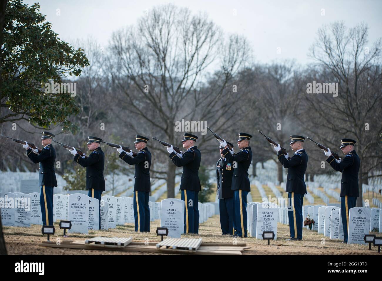 The U.S. Army Honor Guard firing party fires 3 folleys during the funeral of U.S. Army Sgt. 1st Class Mihail Golin in Section 60 of Arlington National Cemetery, Arlington, Virginia, Jan. 22, 2018. Golin, an 18B Special Forces Weapons Sergeant assigned to 10th Special Forces Group (Airborne) died Jan. 1, 2018, as a result of wounds sustained while engaged in combat operations in Nangarhar Province, Afghanistan.  Golin deployed to Afghanistan in September 2017 with the 2nd Battalion, 10th Special Forces Group, in support of Operation Freedom’s Sentinel.  Golin enlisted Jan. 5, 2005 and this was Stock Photo