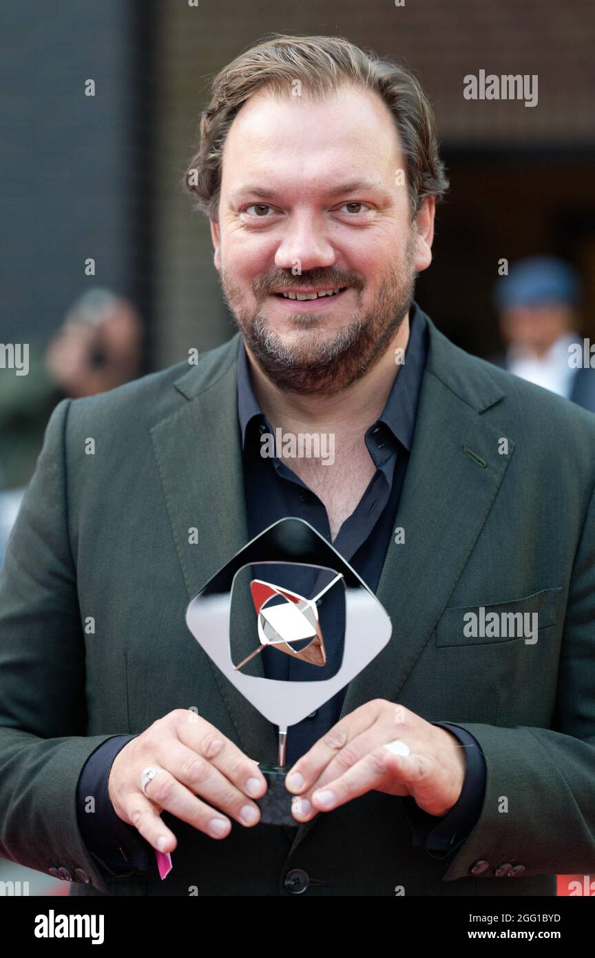 Marl Germany 27th Aug 2021 Actor Charly Hubner Holds The Award In The Fiction Category For The Film Fur Immer Sommer 90 Before The 57th Grimme Awards Ceremony Credit Henning Kaiser Dpa Alamy Live