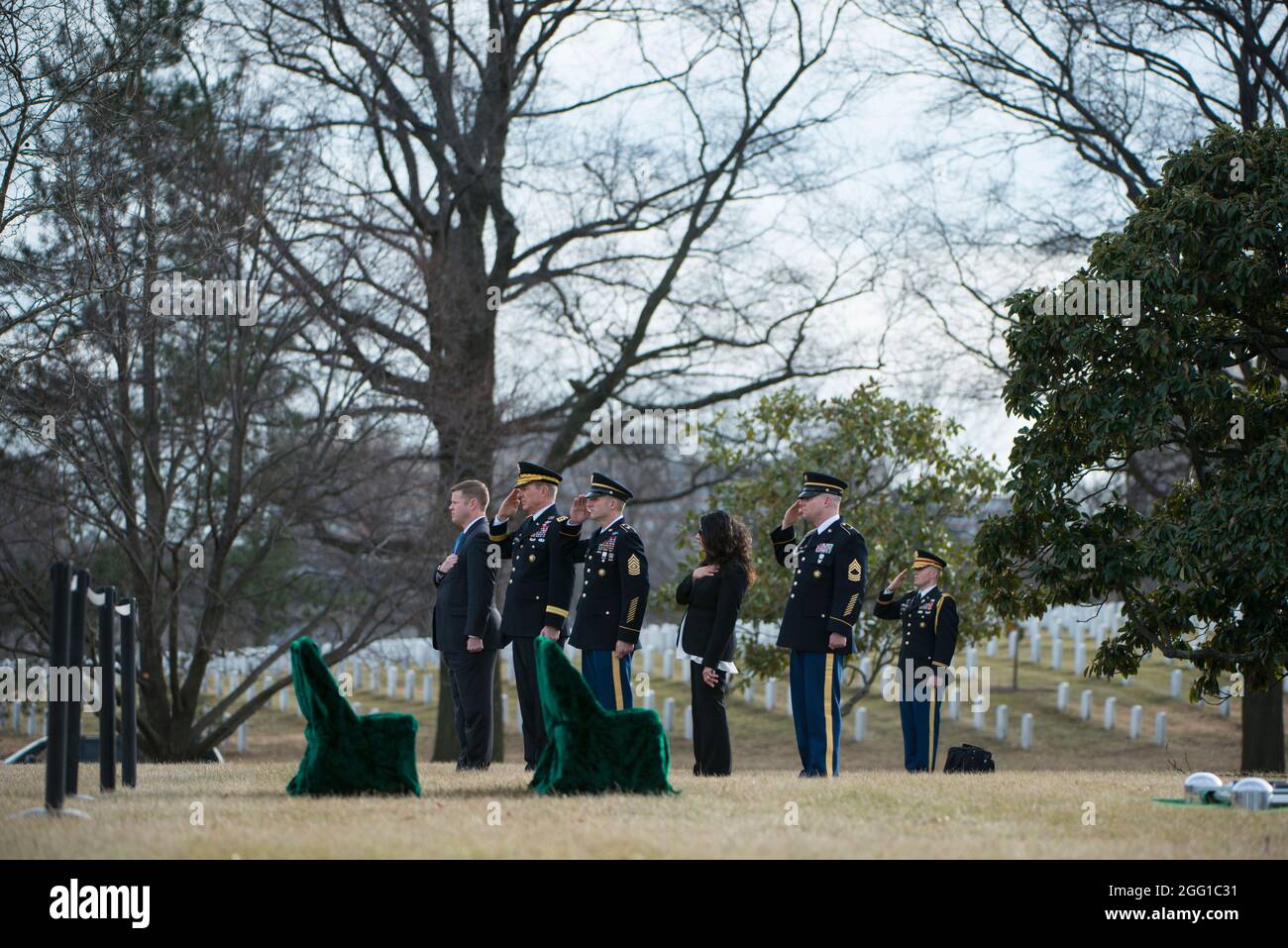 (From the left) Under Secretary of the Army Ryan McCarthy; Vice Chief of Staff of the Army Gen. James McConville; Sgt. Maj. of the Army Daniel Dailey; Executive Director of Army National Military Cemeteries Karen Durham-Aguilera; and Arlington National Cemetery Senior Enlisted Advisor Master Sgt. Todd Parsons; render honors during the full honors gravesite service for U.S. Army Sgt. 1st Class Mihail Golin, in Section 60 of Arlington National Cemetery,  Arlington, Virginia, Jan. 22, 2018. Golin, an 18B Special Forces Weapons Sergeant assigned to 10th Special Forces Group (Airborne) died Jan. 1, Stock Photo