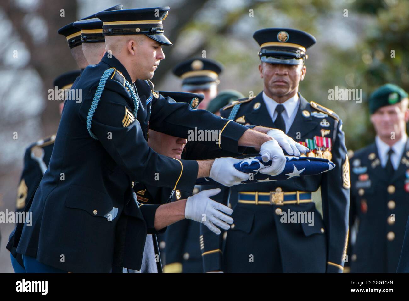 The U.S. Army Honor Guard, The 3d U.S. Infantry Regiment (The Old Guard) Caisson Platoon, and The U.S. Army Band, “Pershing’s Own”, conduct the funeral of U.S. Army Sgt. 1st Class Mihail Golin in Section 60 of Arlington National Cemetery, Arlington, Virginia, Jan. 22, 2018. Golin, an 18B Special Forces Weapons Sergeant assigned to 10th Special Forces Group (Airborne) died Jan. 1, 2018, as a result of wounds sustained while engaged in combat operations in Nangarhar Province, Afghanistan.  Golin deployed to Afghanistan in September 2017 with the 2nd Battalion, 10th Special Forces Group, in suppo Stock Photo
