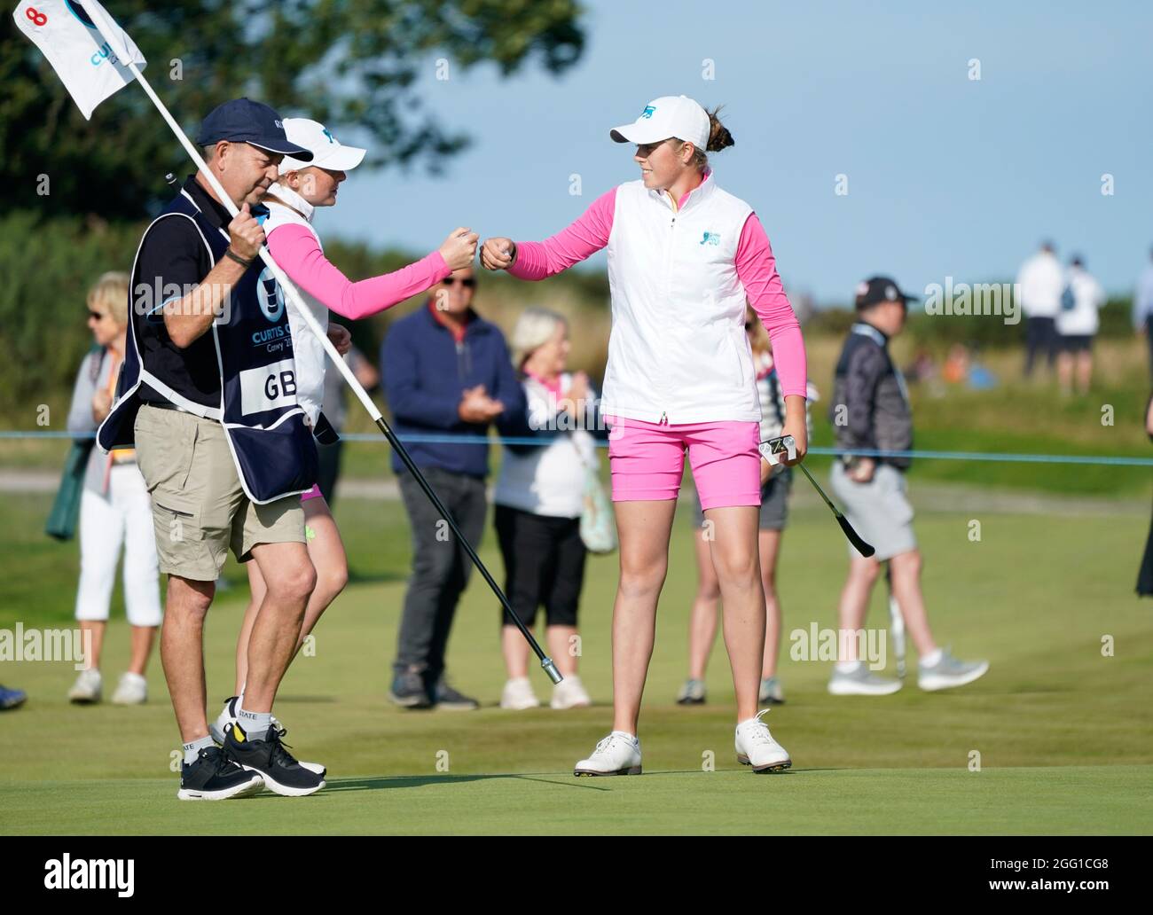 Team GB&I's Louise Duncan fist pumps with Hannah Darling after winning the 8th hole during the 2021 Curtis Cup Day 2 - Morning Foursomes at Conwy Golf Stock Photo