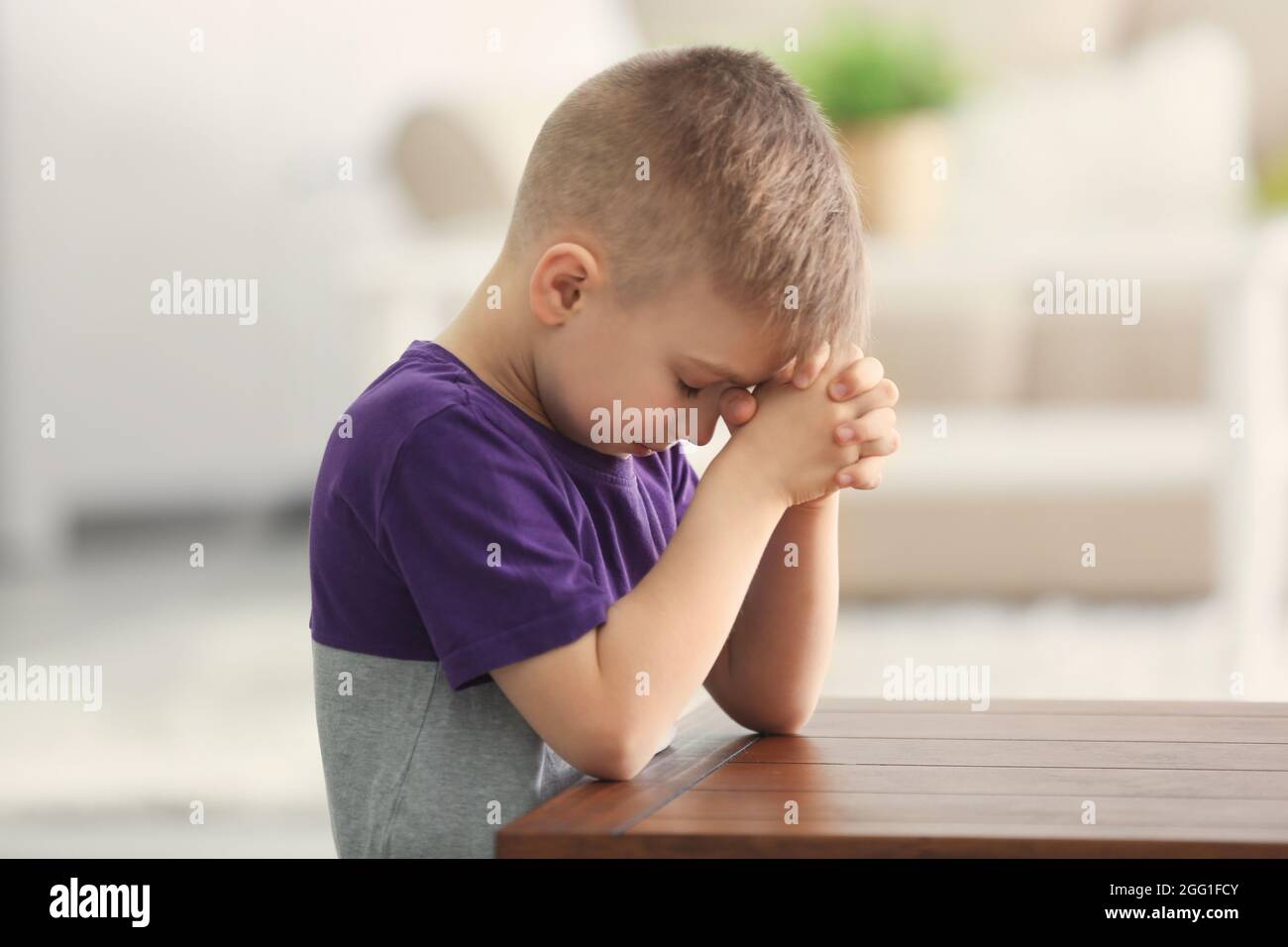 Cute little boy praying at home Stock Photo Alamy