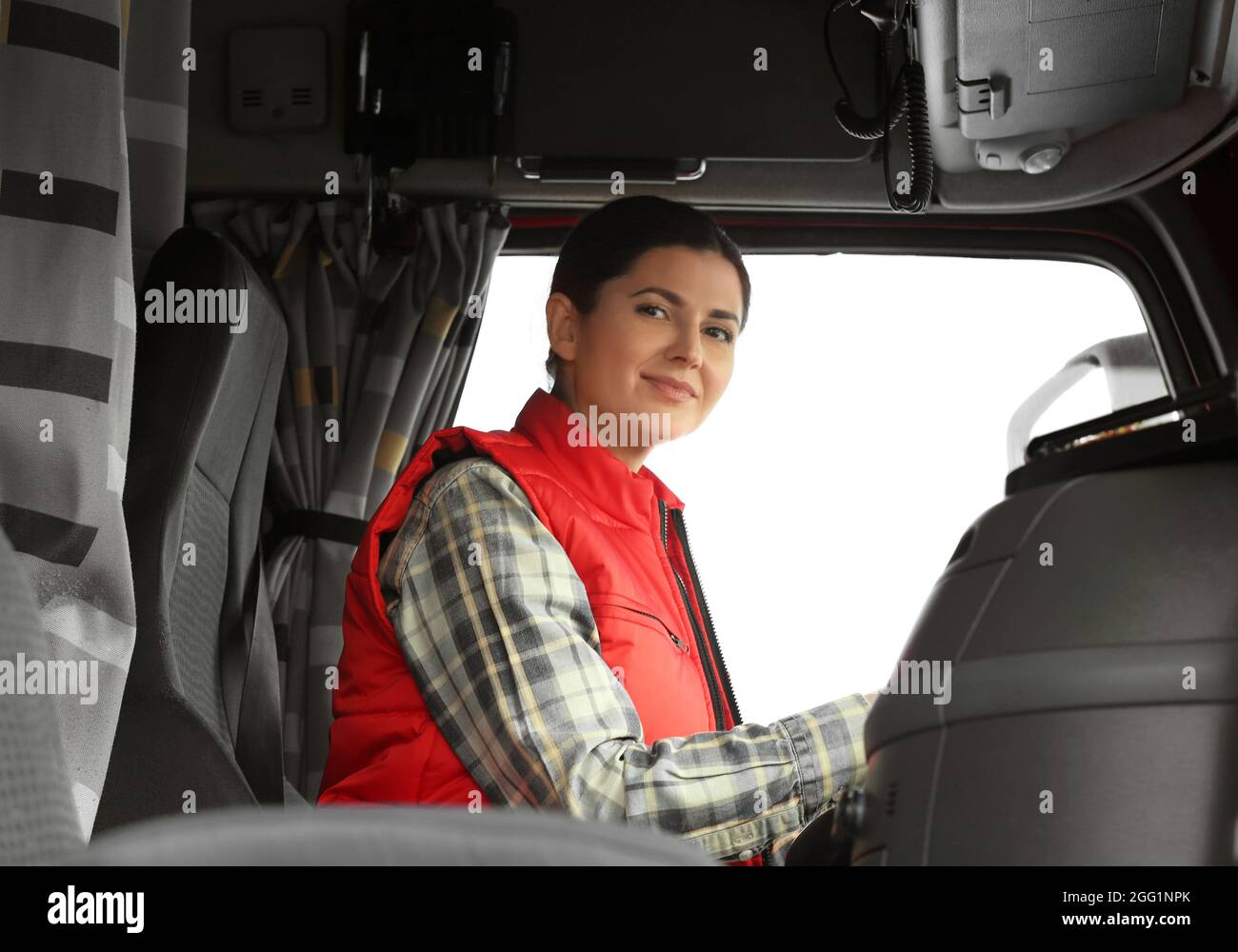 Female driver in cabin of big modern truck Stock Photo - Alamy
