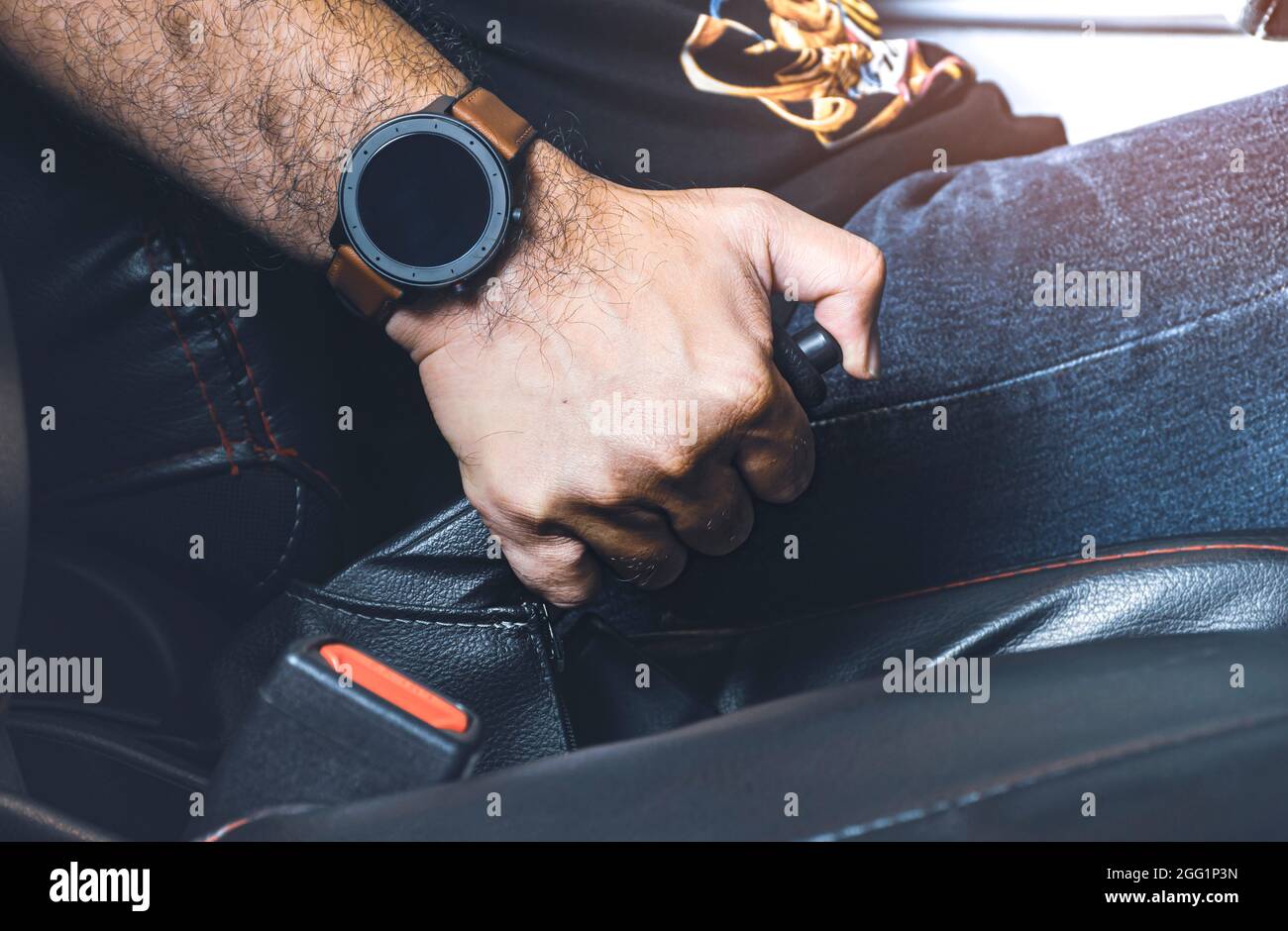 Car driver pulling handbrake lever in the car on the parking Stock