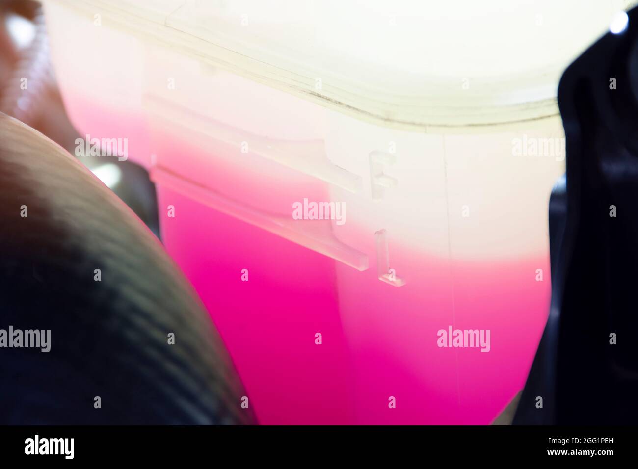 Full and low level in the coolant reservoir tank of the car radiator