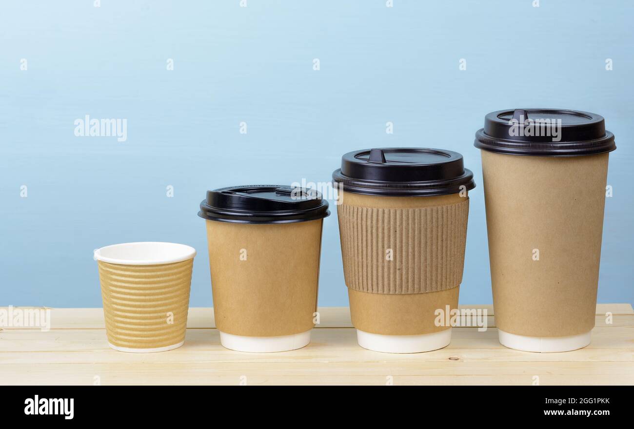 Paper coffee cups on a wooden table Stock Photo - Alamy