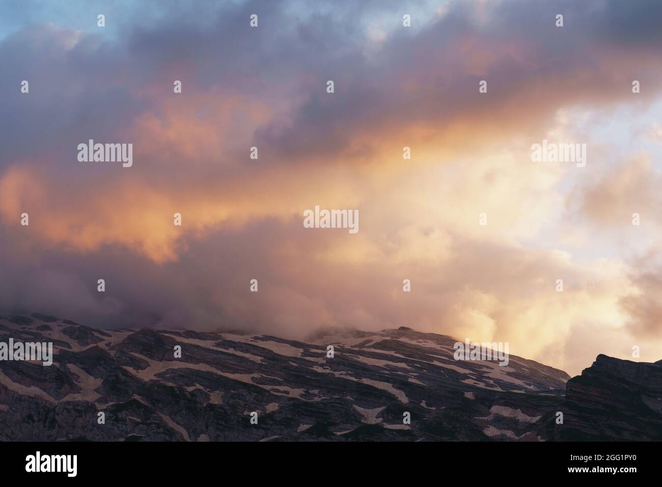 Beautiful sunset sky with clouds over the mountain range Stock Photo ...