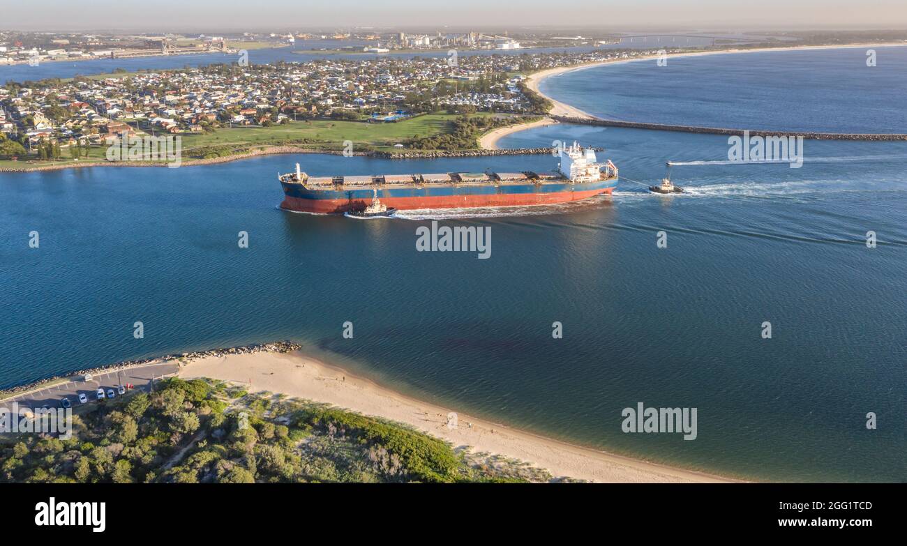 A large coal ship entering port at Newcastle NSW Australia. Newcastle Port is one of the largest export coal ports in the world. Stock Photo