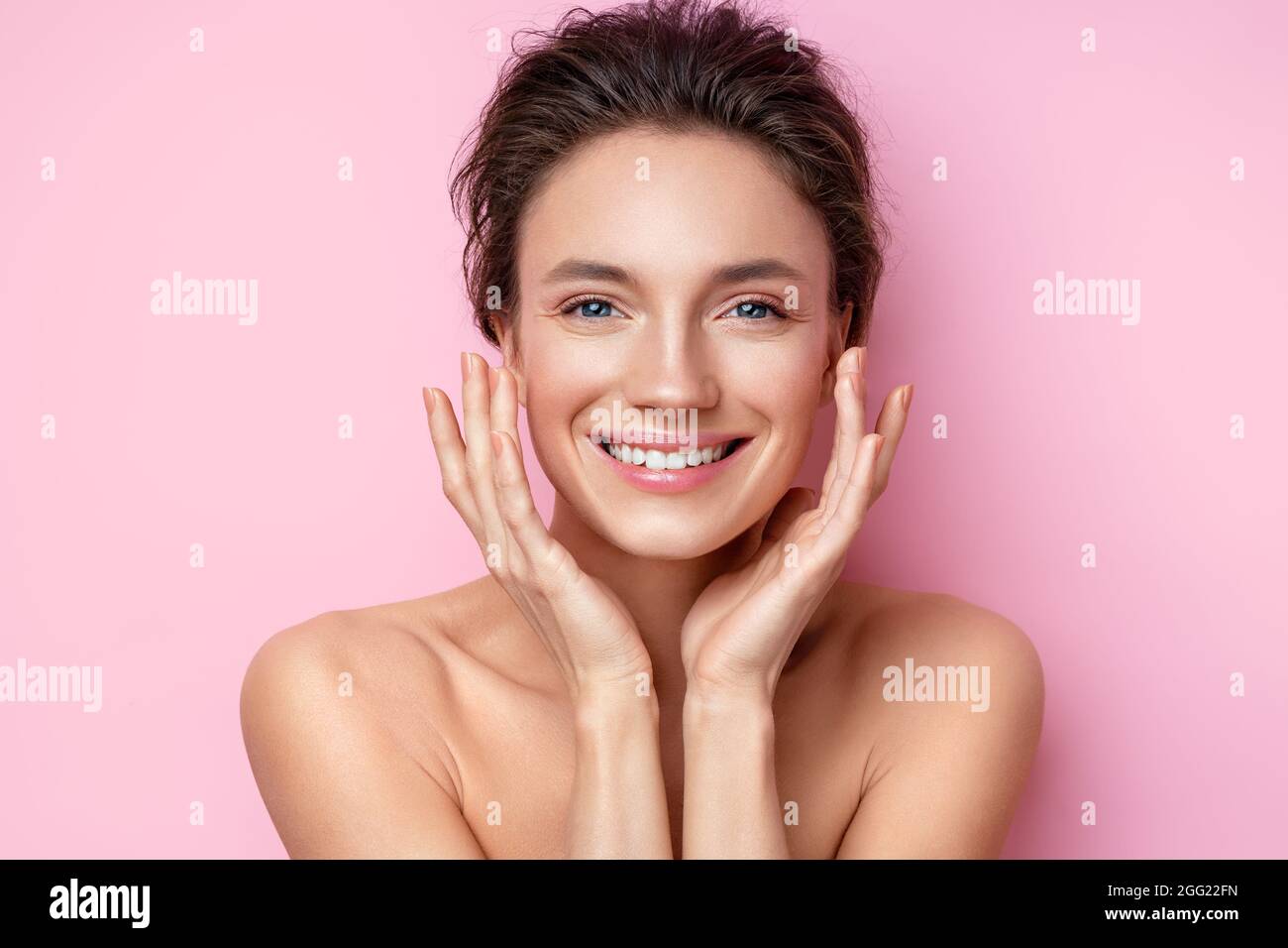 Beautiful woman with perfect skin on pink background. Beauty and skin care concept Stock Photo