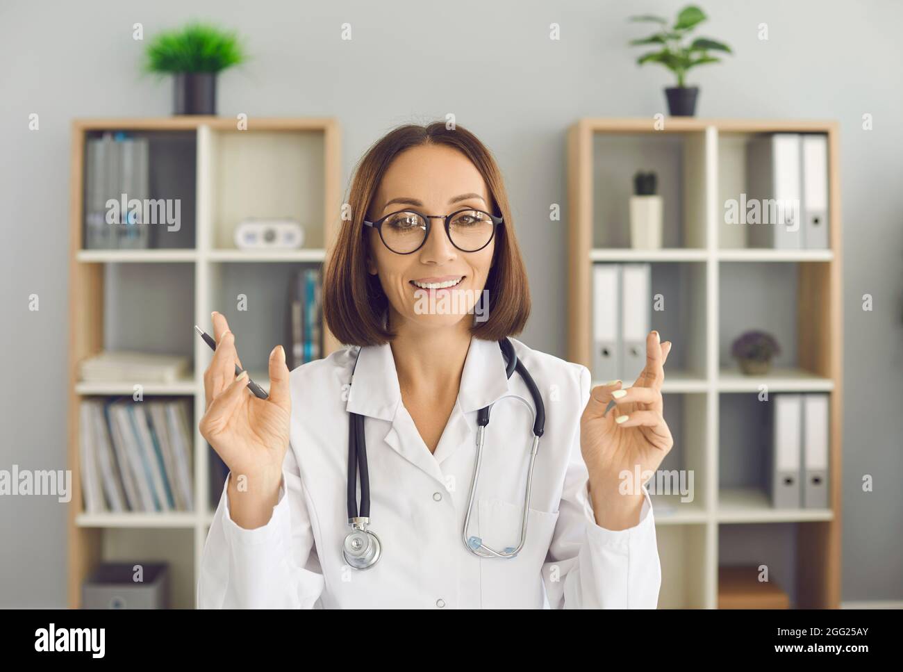 Video conference headshot portrait of happy online doctor looking at camera and talking Stock Photo