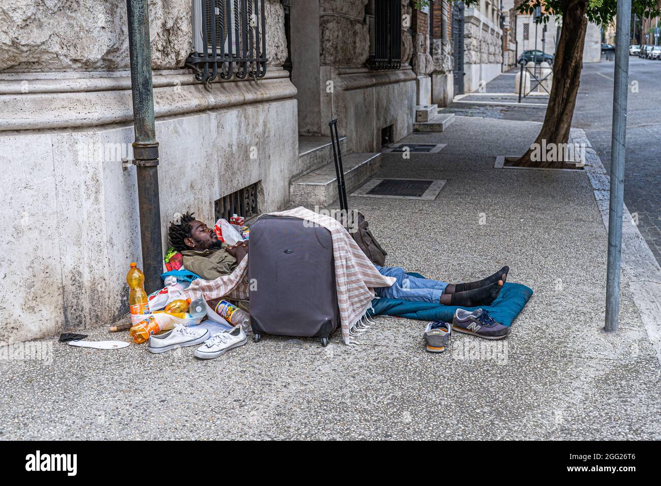 ROME ITALY UK. 28 August 2021. A homeless man sleeps half naked in a