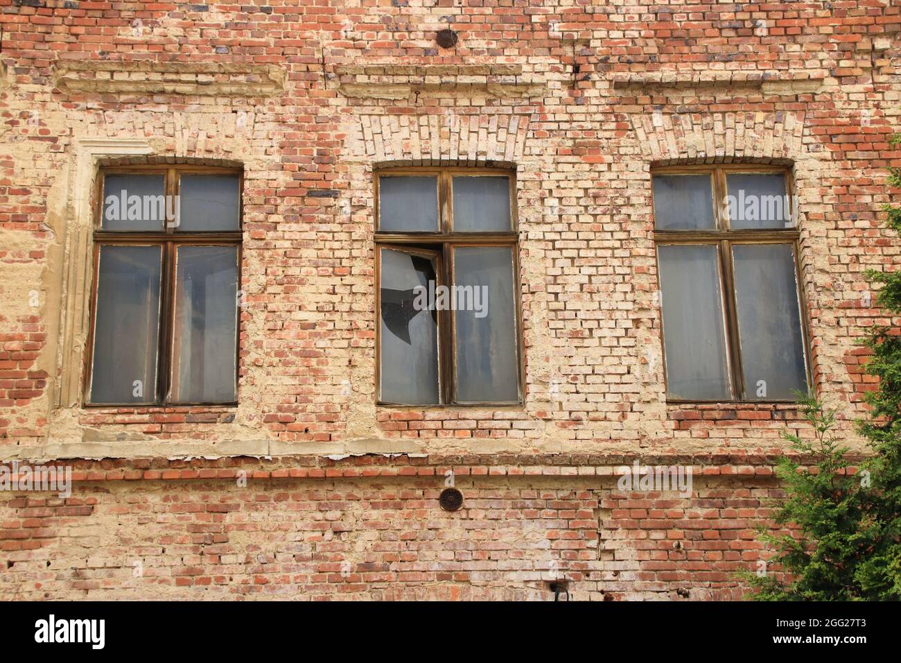 Broken windows in an old brick facade in Görlitz Stock Photo