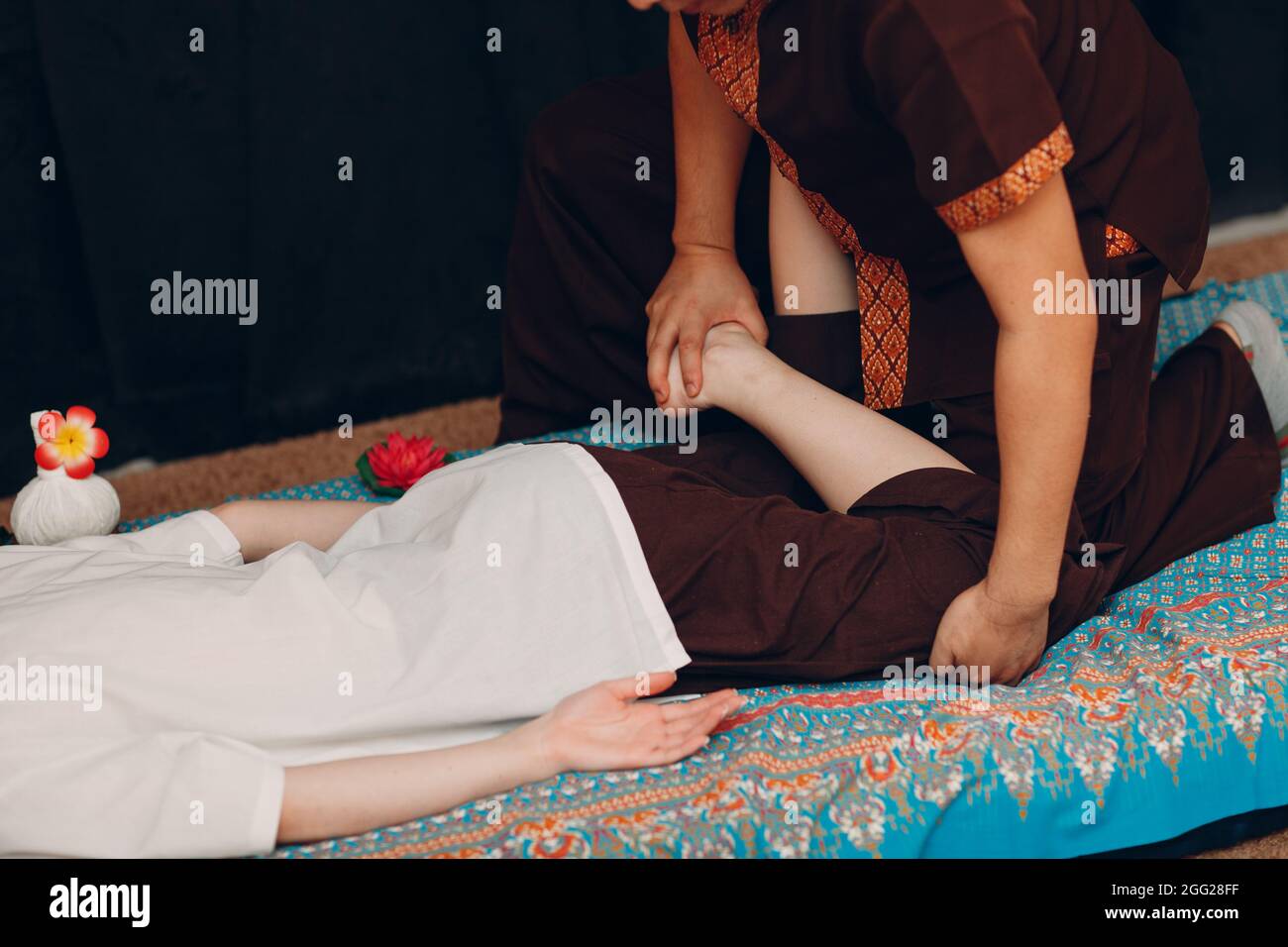 Thai man making classical thai massage procedure to young woman at ...