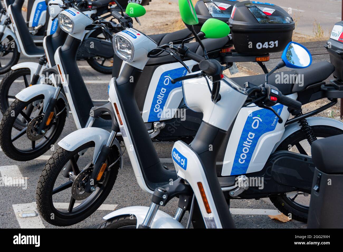 Selfservice rental electric scooters from the Spanish company Cooltra parked in a street of