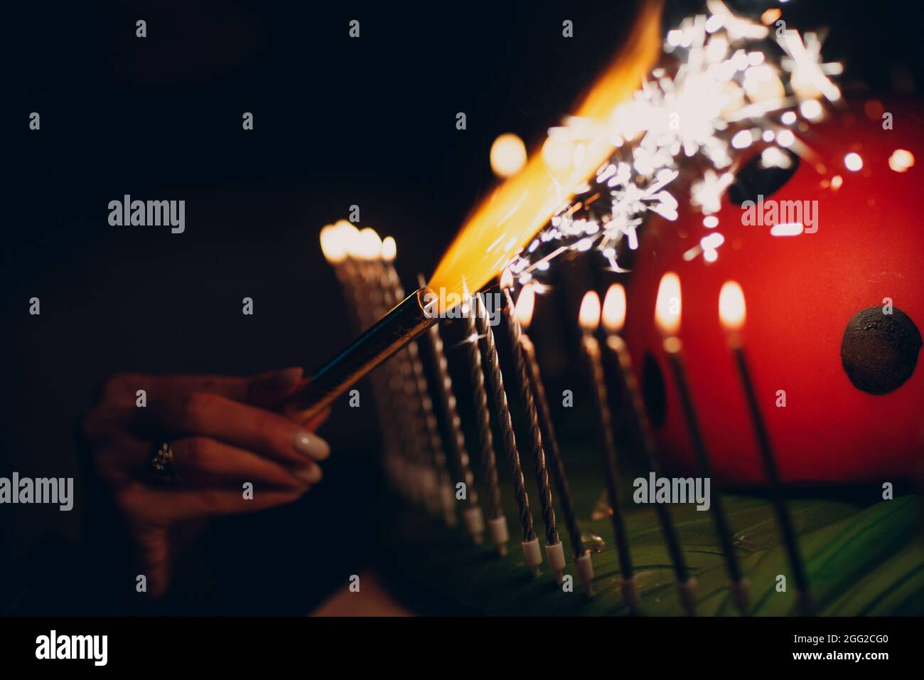 lighting candles with sparklers at a sparkling party in the dark Stock