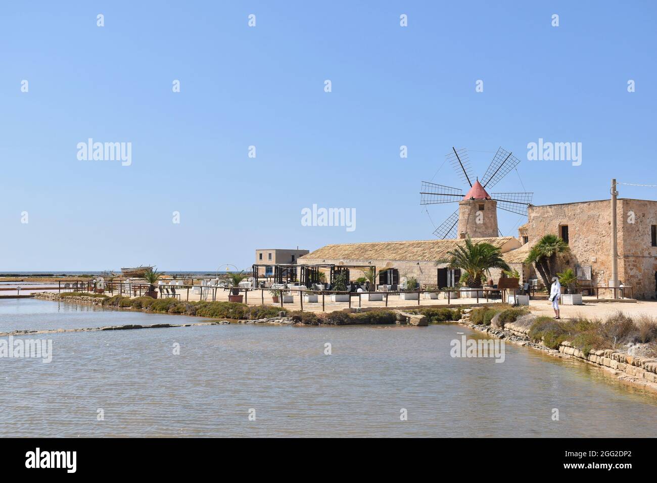 Old windmill in the Salina of Trapani, Sicily, Italy Stock Photo