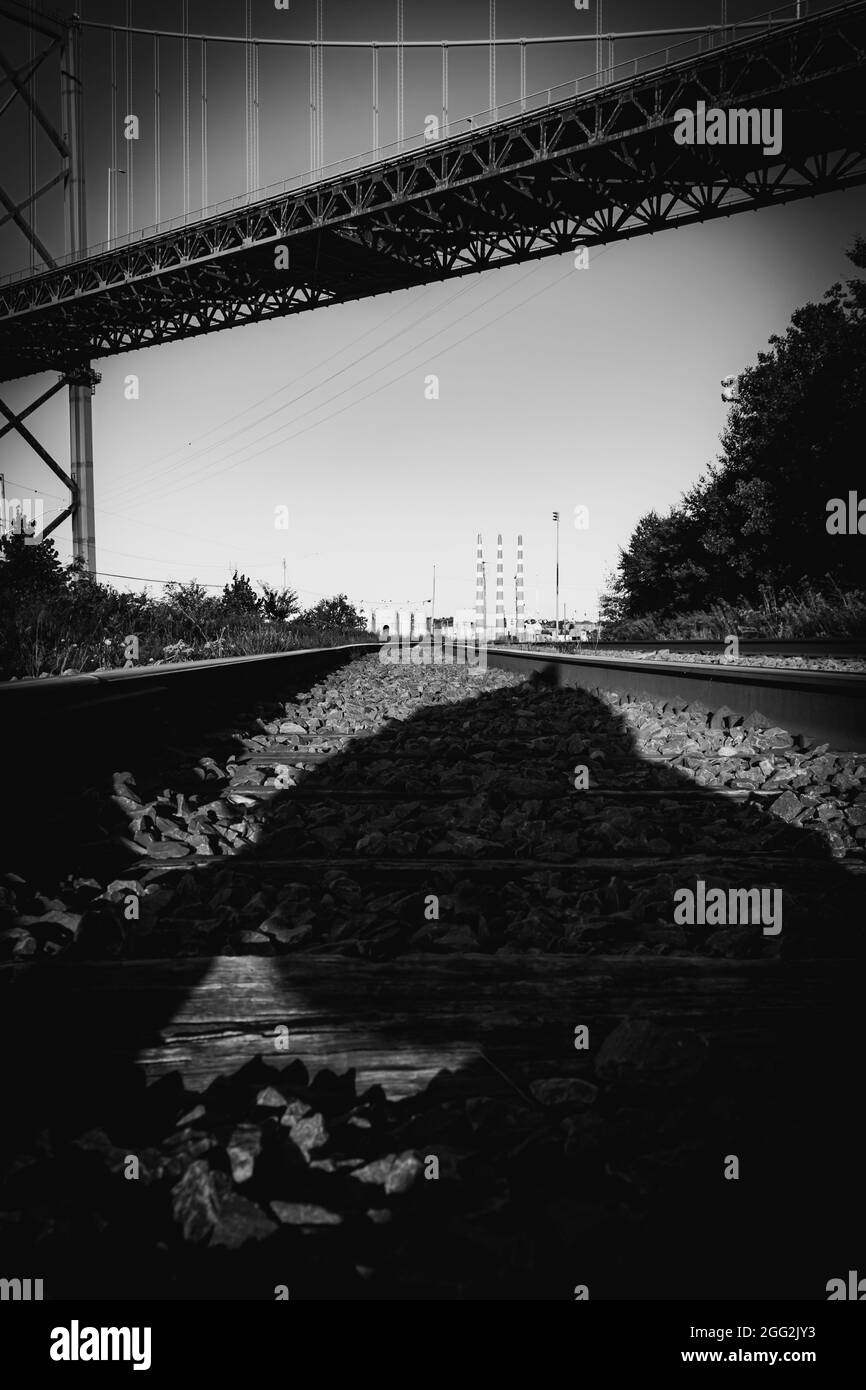 Blak and white photo of railroad tracks under the Mackay Bridge in nova scotia Stock Photo
