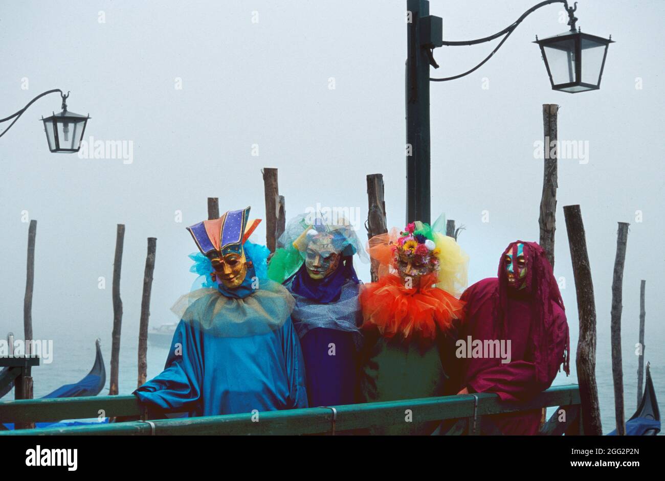 Persons in costumes pose on the Venice berth Near Piazza San Marco Stock Photo