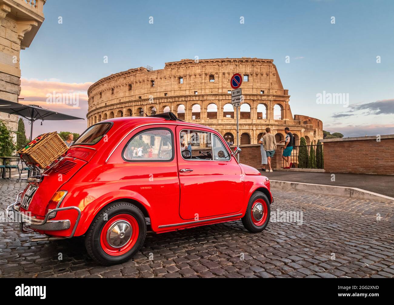 Little red old Fiat 500 in front of coliseum at sunset with picnic basket  on rear Stock Photo - Alamy