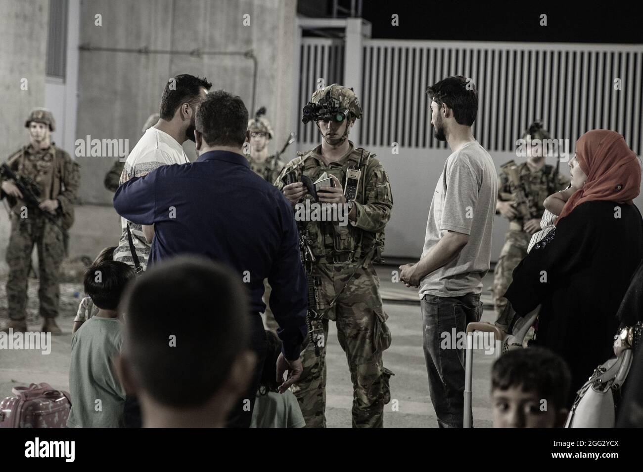 Kabul, Afghanistan. 28th Aug, 2021. U.S. Soliders with the 82nd Airborne Division assist evacuees during an evacuation at Hamid Karzai International Airport, in Kabul, Afghanistan, on August 25, 2021. U.S. service members are assisting the Department of State with a non-combatant evacuation operation (NEO) in Afghanistan. Photo by Staff Sgt. Victor Mancilla/USMC/UPI Credit: UPI/Alamy Live News Stock Photo