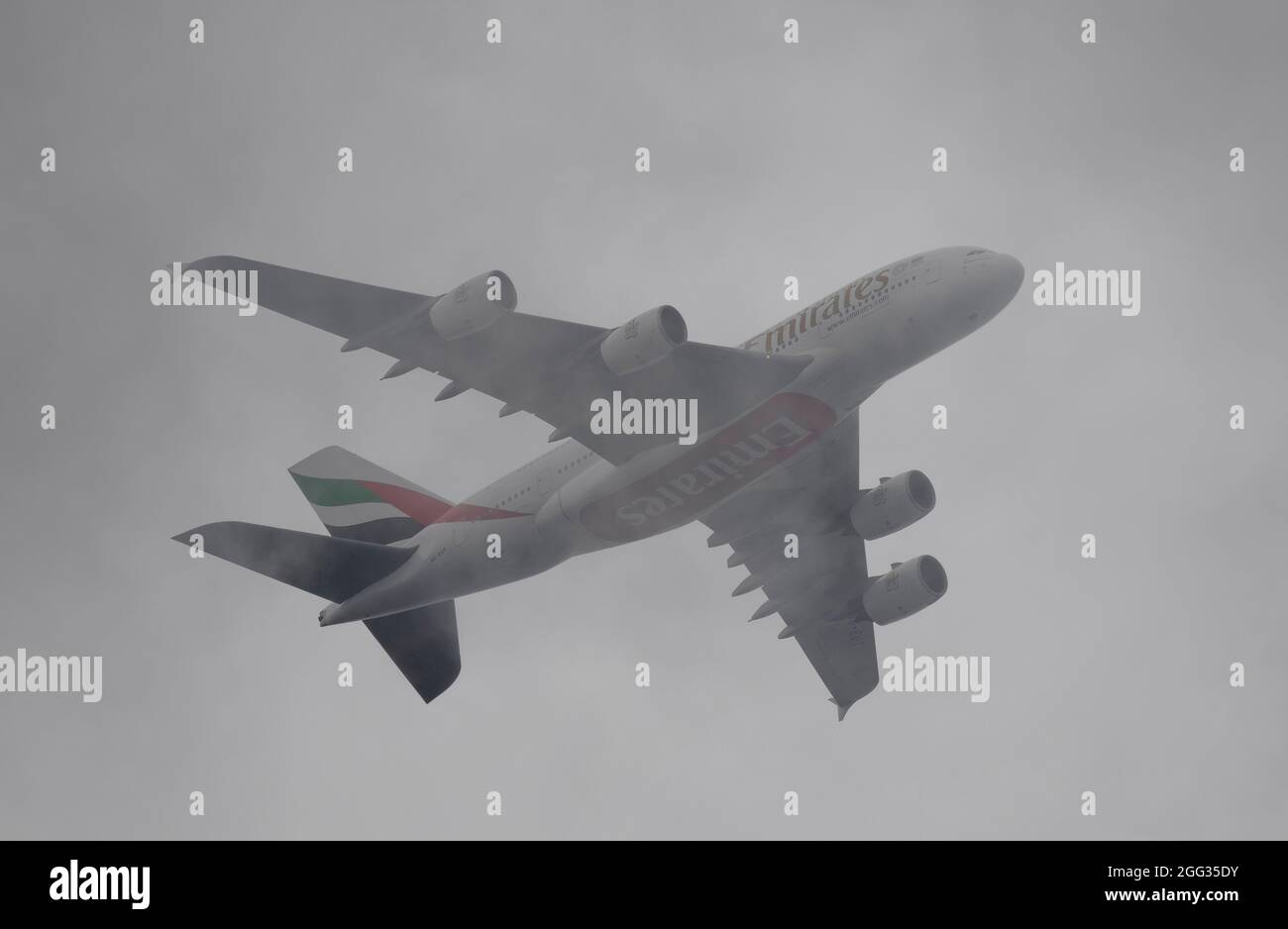 London, UK. 28 August 2021. A6-EUT Emirates Airbus A380 in thick cloud above London after leaving Heathrow en route to Dubai UAE Stock Photo