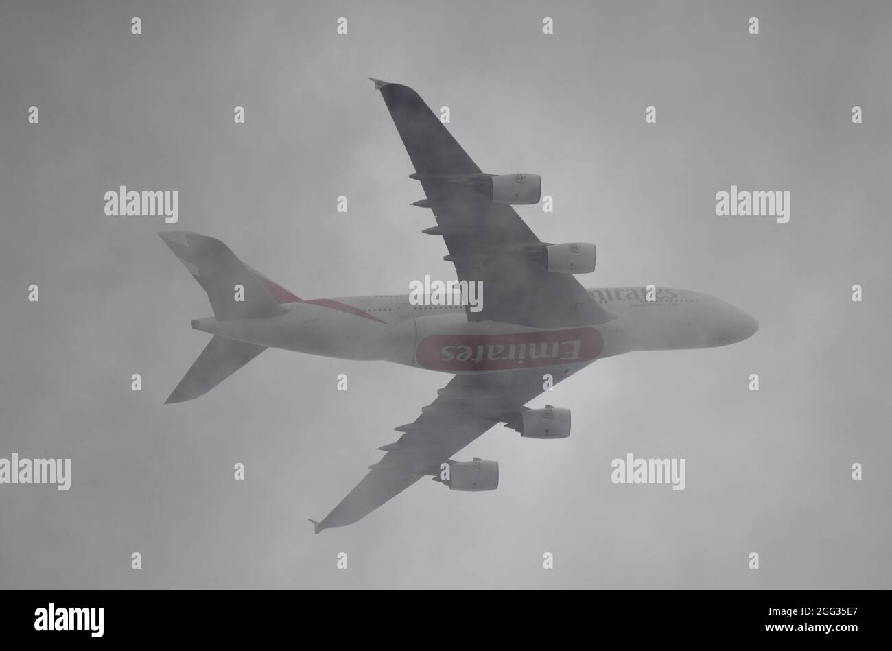 London, UK. 28 August 2021. A6-EUT Emirates Airbus A380 in thick cloud above London after leaving Heathrow en route to Dubai UAE Stock Photo
