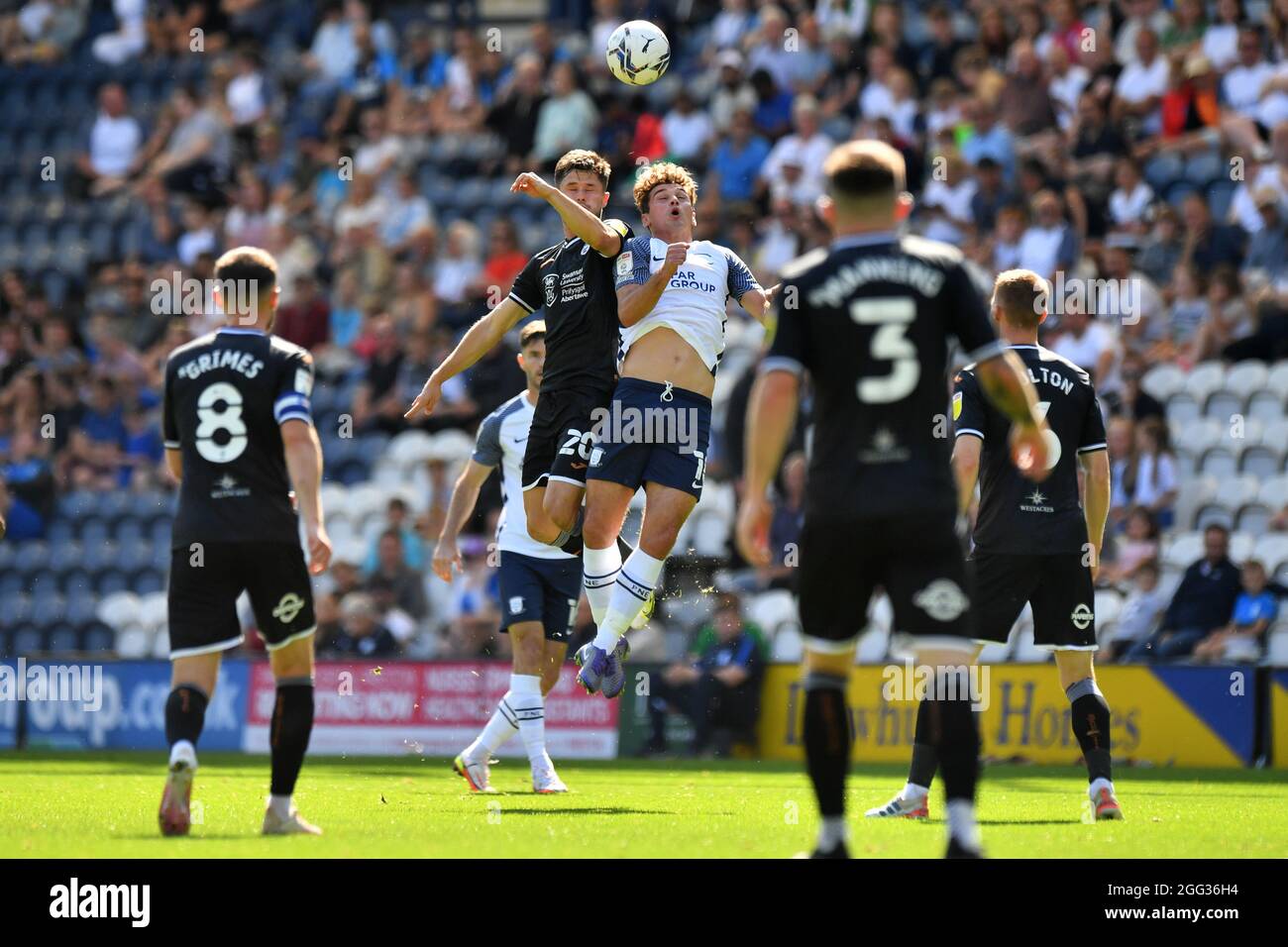 Preston North End's Ryan Ledson and Swansea City's Liam Cullen compete for a header during the Sky Bet Championship match at the Deepdale Stadium, Preston. Picture date: Saturday August 28, 2021. Stock Photo
