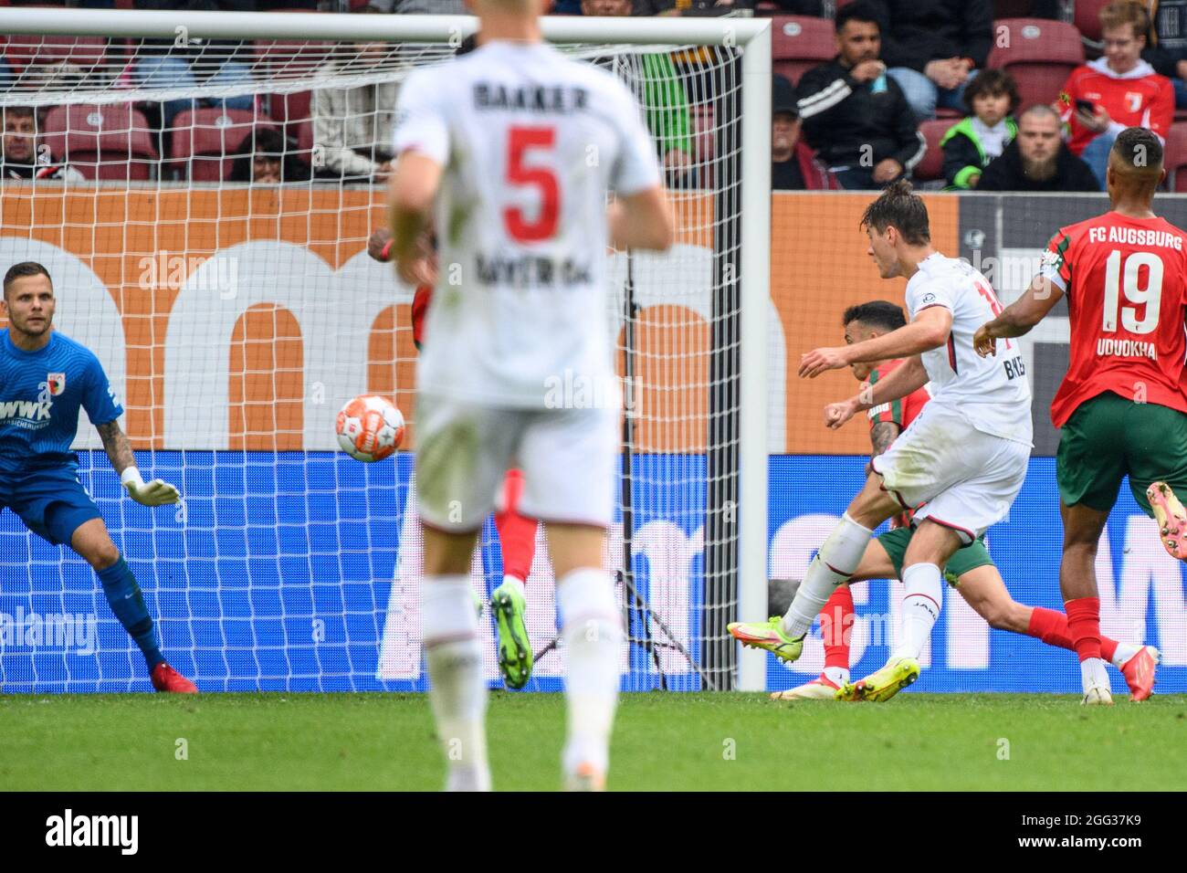 28 August 2021, Bavaria, Augsburg: Football: Bundesliga, FC Augsburg - Bayer Leverkusen, Matchday 3, WWK Arena. Leverkusen's Patrik Schick (r) scores to make it 1 - 3. Augsburg goalkeeper Rafal Gikiewicz (left) is unable to keep out the ball. In the centre Iago from Augsburg tries to defend. Photo: Matthias Balk/dpa - IMPORTANT NOTE: In accordance with the regulations of the DFL Deutsche Fußball Liga and/or the DFB Deutscher Fußball-Bund, it is prohibited to use or have used photographs taken in the stadium and/or of the match in the form of sequence pictures and/or video-like photo series. Stock Photo