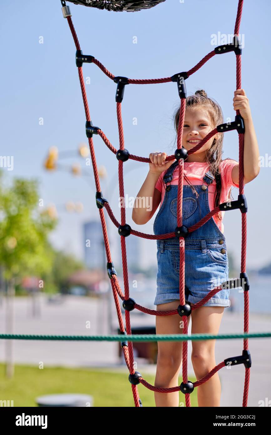 child girl having fun on playground in sunny day Stock Photo - Alamy