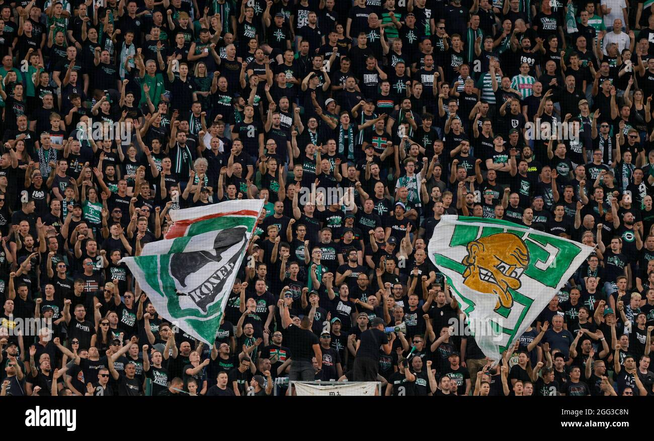 BUDAPEST, HUNGARY - AUGUST 4: Ultras of Ferencvarosi TC support their team during the UEFA Champions League Third Qualifying Round 1st Leg match between Ferencvarosi TC and SK Slavia Praha at Ferencvaros Stadium on August 4, 2021 in Budapest, Hungary. Stock Photo