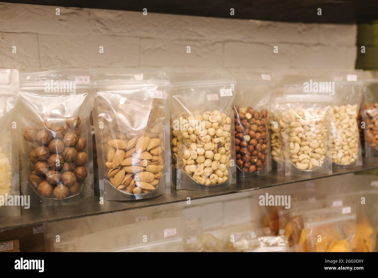 Various nuts packaged in the package for sale at market. Closeup of
