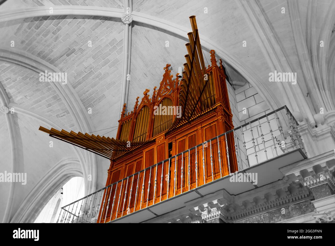 13th century wooden organ with metal trumpets, instrument detail on black and white building background Stock Photo