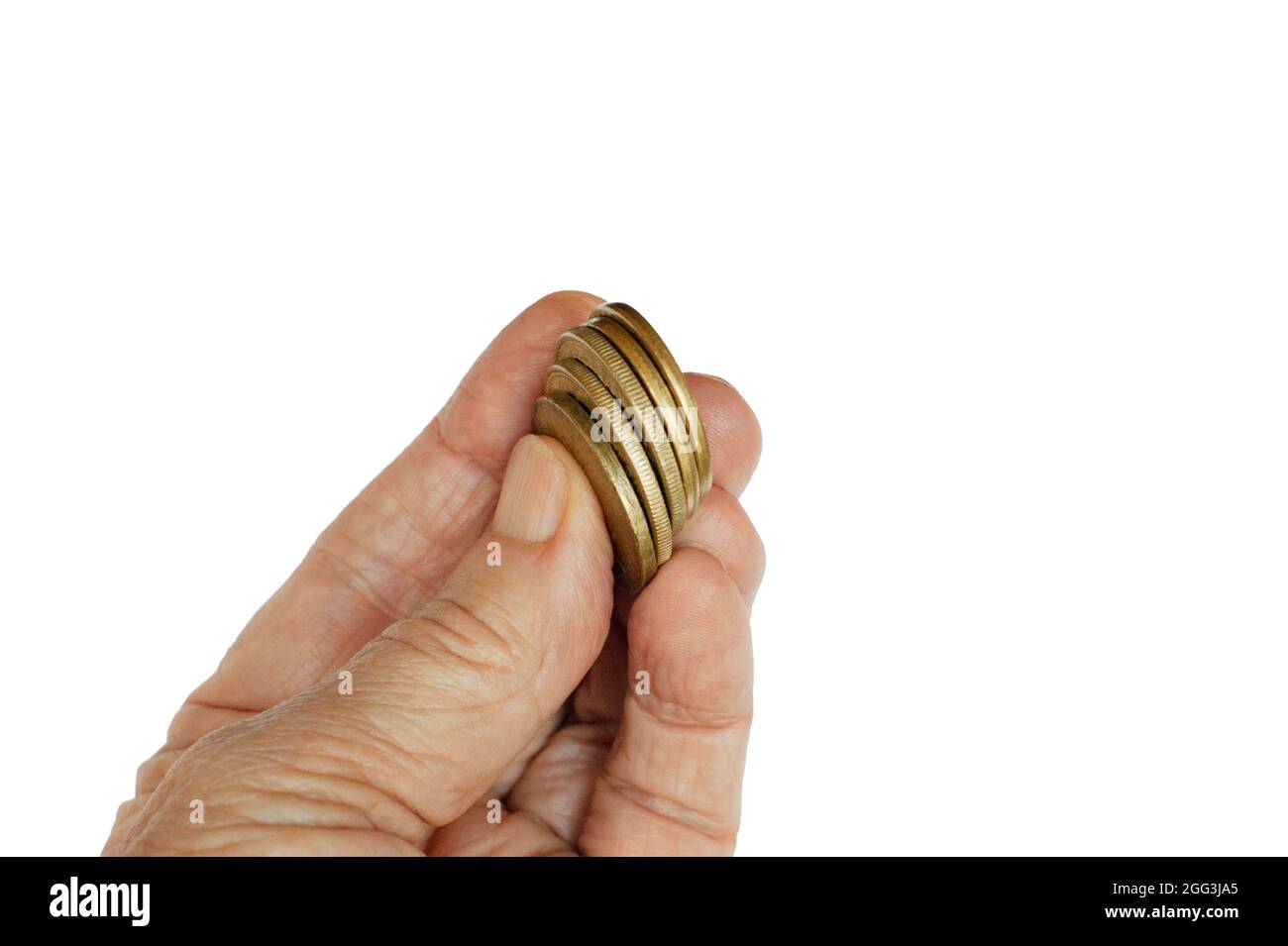 Gold coins held up by fingers or mature hand. Isolated. A group of five gold coins is lifted up to show, to give, to invest. Stock Photo