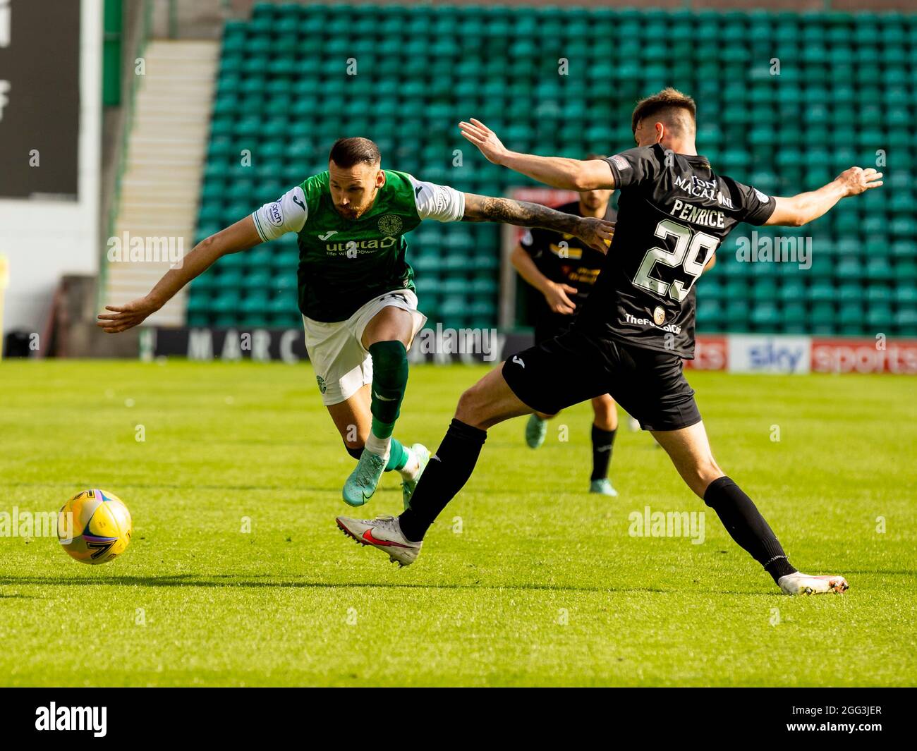 Easter Road, Leith, Edinburg, UK. 28th Aug, 2021. Scottish Premier League football, Hibernian versus Livingston; Martin Boyle of Hibernian skips a challenge from James Penrice of Livingston Credit: Action Plus Sports/Alamy Live News Stock Photo