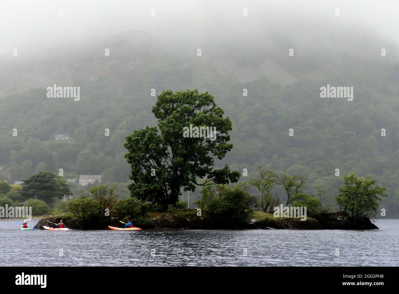 Canoeing at island on Ullswater Lake Stock Photo