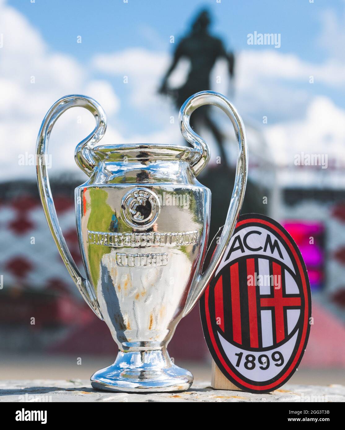 June 14, 2021 Milan, Italy. A.C. Football Club emblem Milan and the UEFA  Champions League Cup against the backdrop of a modern stadium Stock Photo -  Alamy