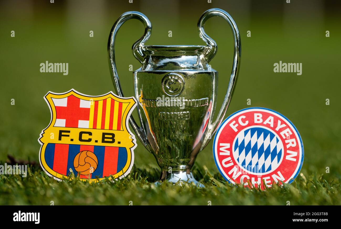 August 27, 2021 Barcelona, Spain. The emblems of football clubs FC Barcelona  and FC Bayern Munich and the UEFA Champions League Cup on the green lawn  Stock Photo - Alamy