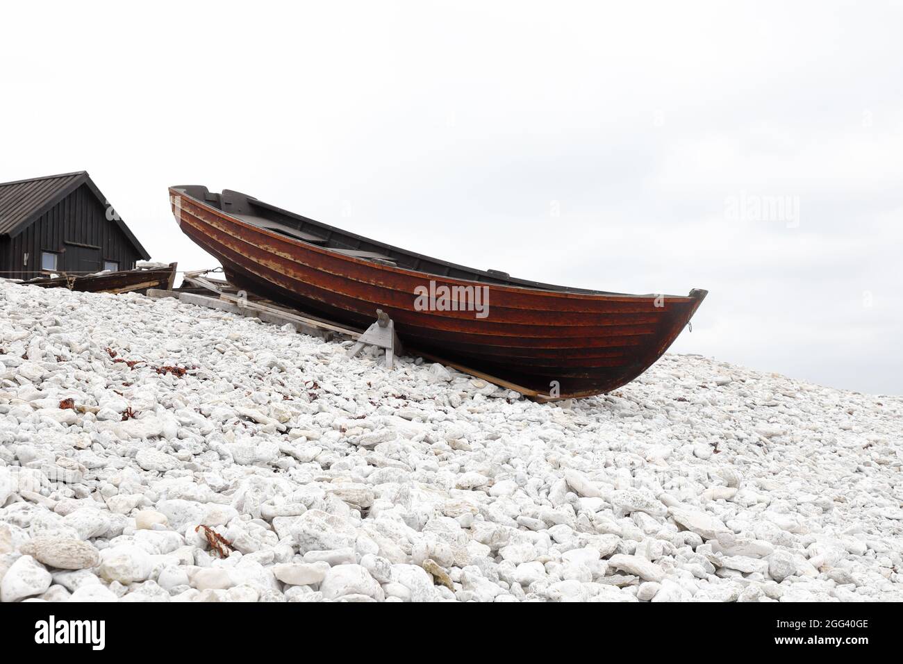 Old wooden open small fishing boat at the Helgumannen fishing station in Swedish province of Gotland. Stock Photo