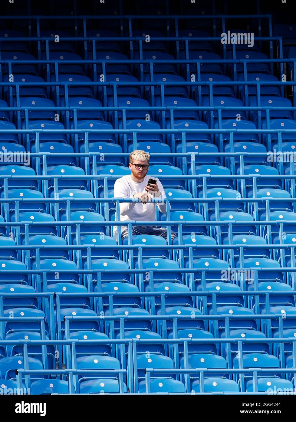 Manchester, England, 28th August 2021.  A fan sits in the safe standing area before the Premier League match at the Etihad Stadium, Manchester. Picture credit should read: Darren Staples / Sportimage Stock Photo