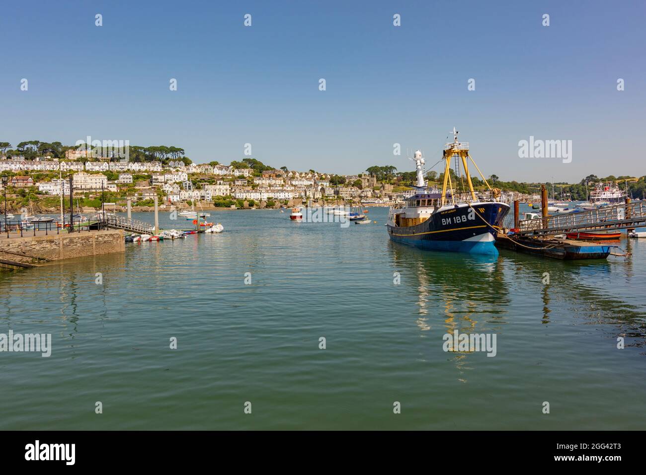 Polruan Quayside with the Trawler 'Sam of Ladram' moored to one side - Polruan, Cornwall, UK. Stock Photo