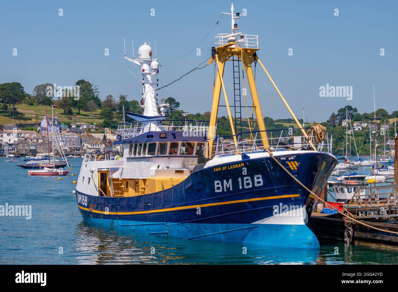 Polruan Quayside with the Trawler 'Sam of Ladram' moored alongside - Polruan, Cornwall, UK. Stock Photo